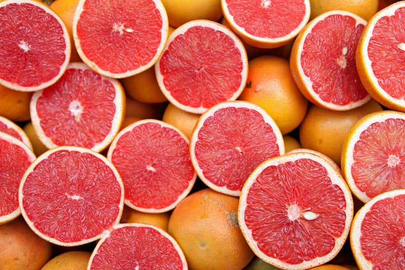 Stack of sliced red grapefruits and oranges